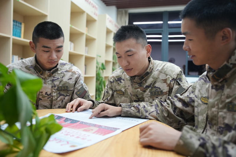 3官兵通过报纸学习“两会”内容。  冯之枫 摄.JPG