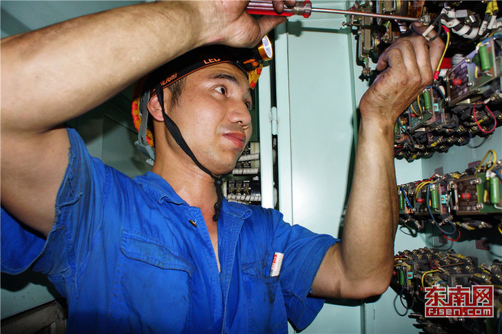 福州机务段永安整备车间电器组职工刘运宁正在对SS4电力机车进行时间继电器检修作业.jpg