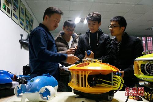1521036811587017237.jpg 苏芃(左一)与团队正在探讨第五代水下机器人相关方案.jpg