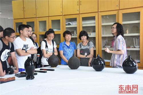 1529753793000008232.jpg 学生参观福建师大漆器展览馆认真听讲.jpg